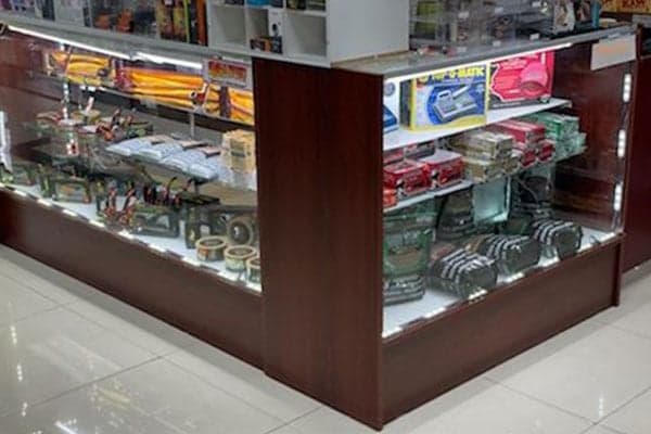 Lit glass display cases at Smokey News.