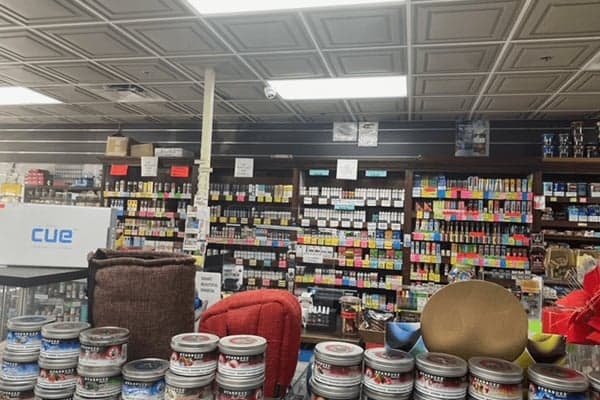 Hookah tobacco and supplies along the aisle at Smokey News.